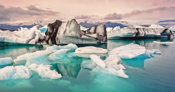 Geothermal pool and snow-capped mountains in Iceland